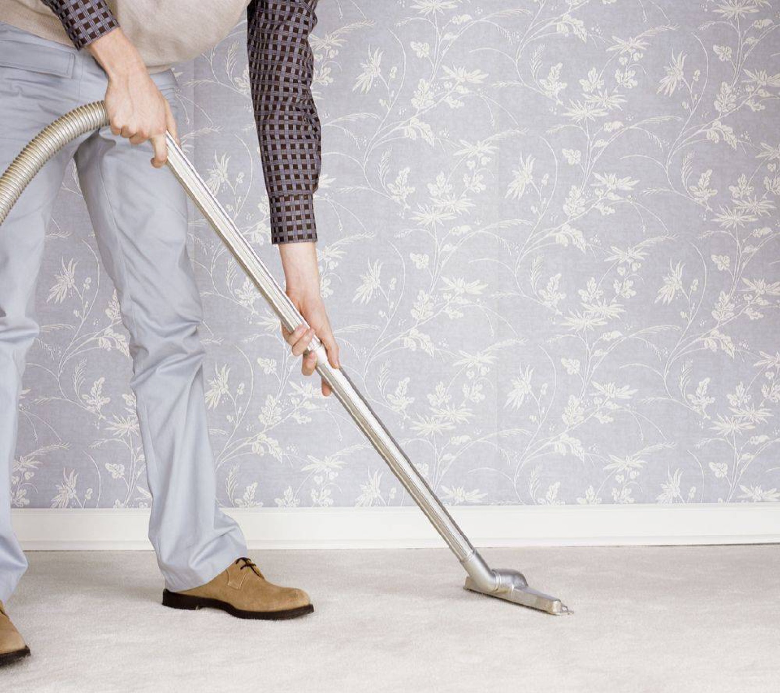 Vacuuming a pale carpet before hot water extraction