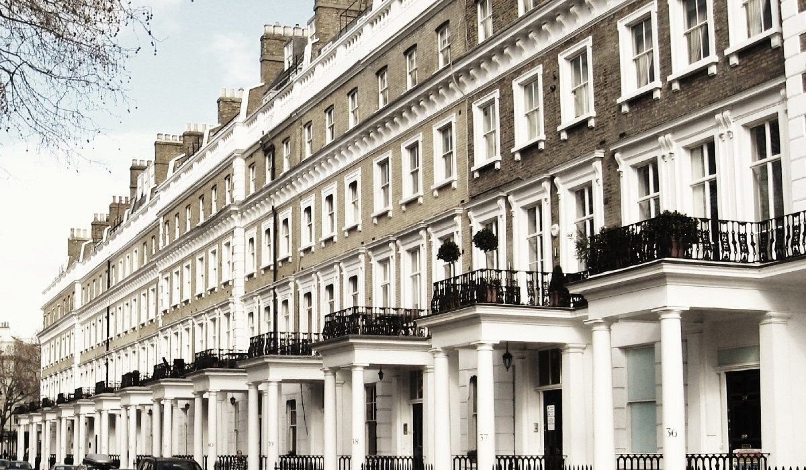Row of white stucco London terraced houses with clean frontages