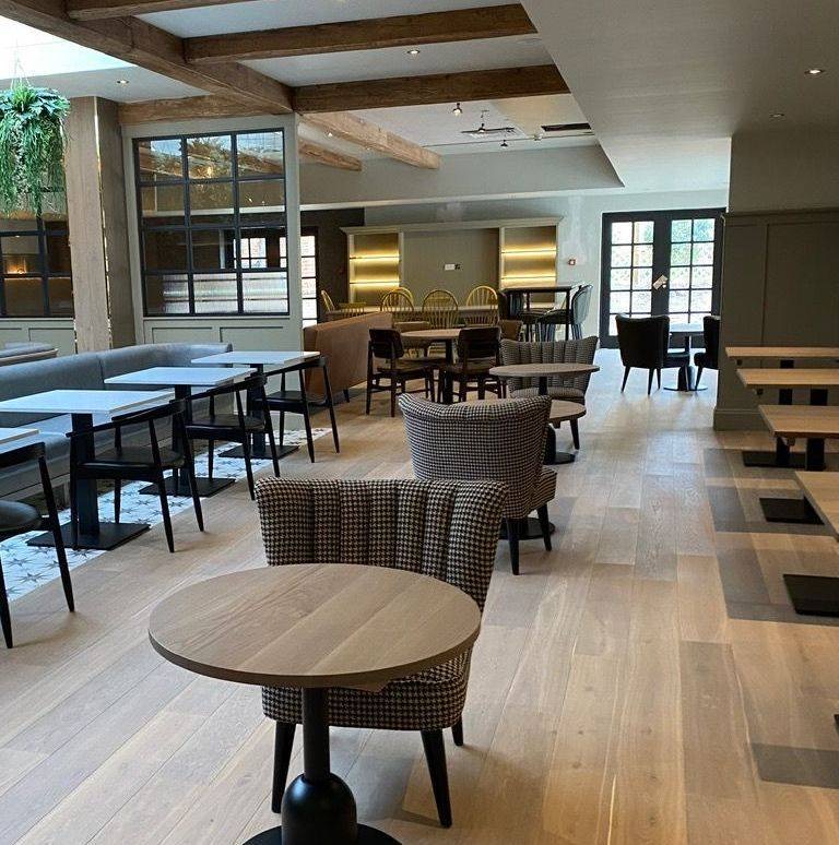 Freshly cleaned restaurant dining area with polished wooden floor